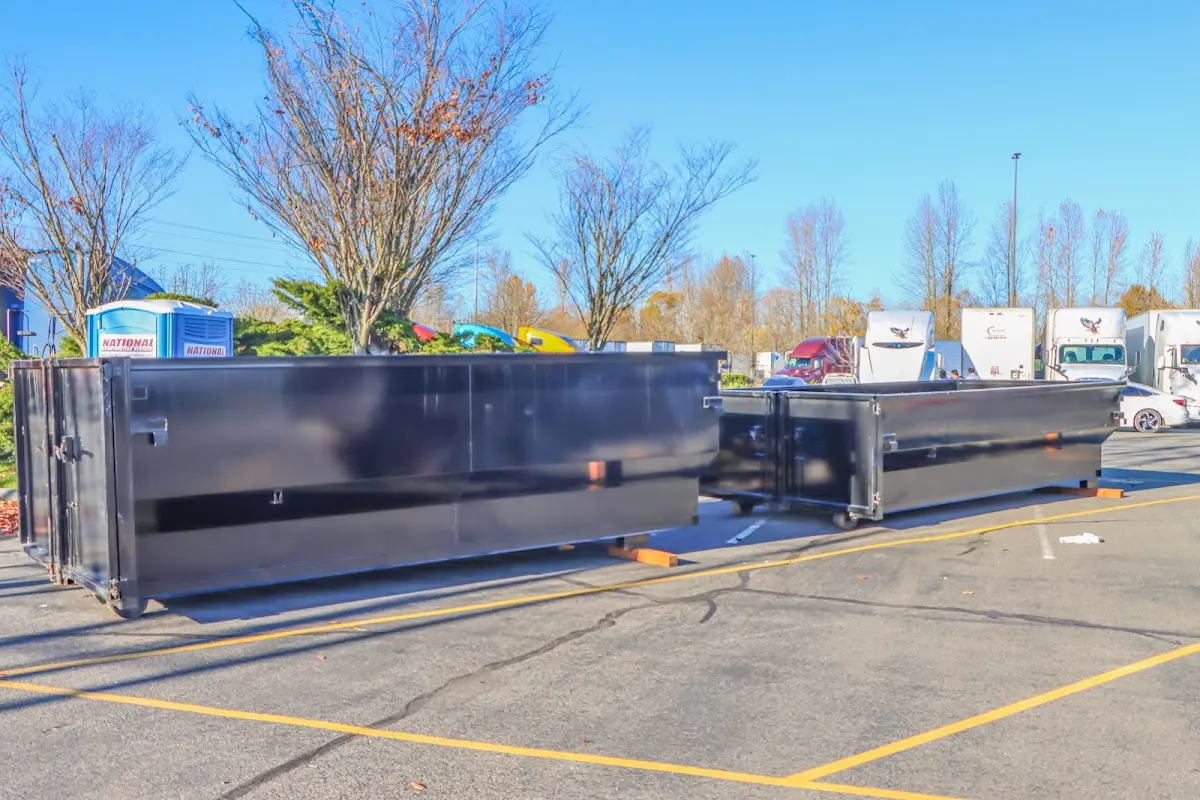 Professional dumpster rental service with roll-off container on residential driveway in Weiser